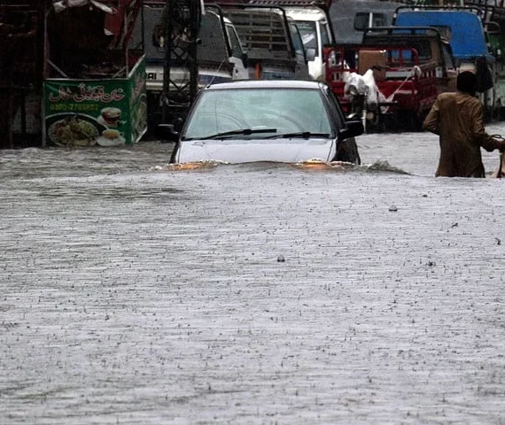 a view of vehicle passing through flooded road during heavy monsoon rains in rawalpindi on july 17 photo inp