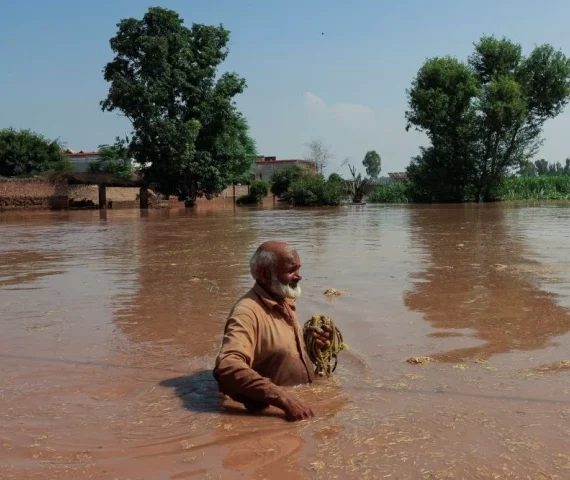 a resident wades through a flooded area following monsoon rains and rising water levels in qadirabad village near the chenab river in punjab province pakistan august 28 2025 photo reuters