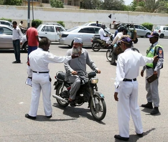 traffic police officers questioning to a bike rider in karachi photo express