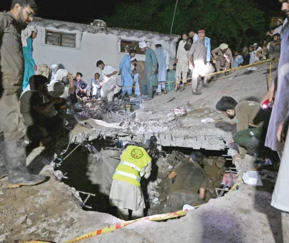 rescue workers and residents search for victims in the debris of a collapsed house after a cloudburst in dolari village of swabi district photo afp