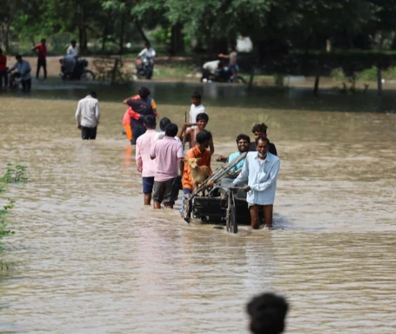 people wade through a flooded road after a rise in the water level of river yamuna due to heavy monsoon rains in new delhi india september 3 2025 photo reuters