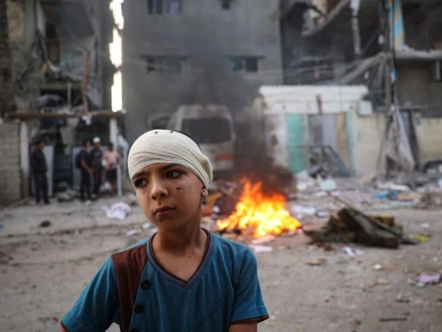 an injured palestinian boy stands next to the rubble of a family house in rafah southern gaza palestine may 20 2024 photo afp