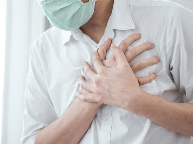 man wear medical face mask symptoms of coronavirus diseases chest pain photo file