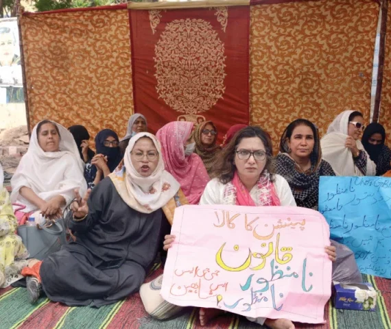 government employees hold placards denouncing pension deductions at the hunger strike camp outside kpc photo jalal qureshi express