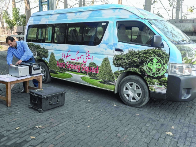 this file photo shows an anti smog squad lab technician preparing to inspect emissions at a factory in lahore photo afp