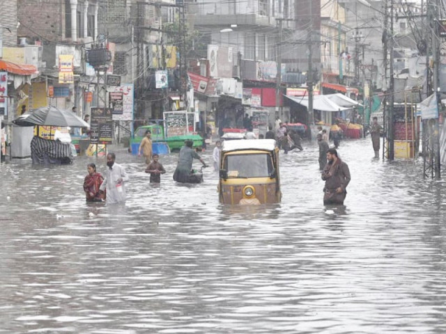 citizens navigate an inundated road in raja bazaar following heavy early morning downpour in the twin cities photos app inp