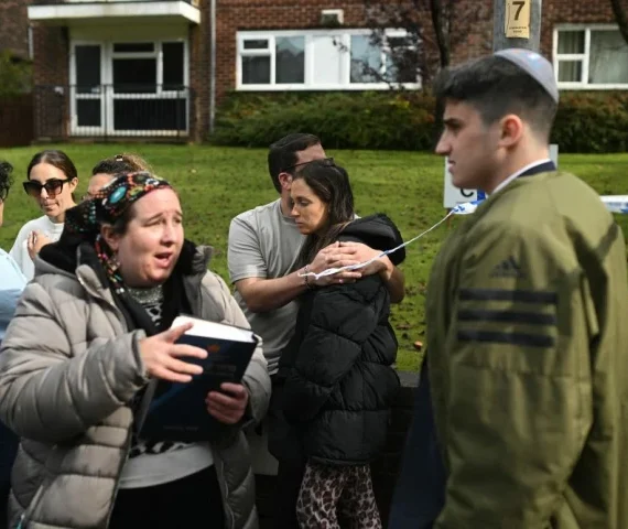 members of the community comfort each other near heaton park hebrew congregation synagogue in crumpsall north manchester on october 2 2025 following a major incident at the synagogue photo afp